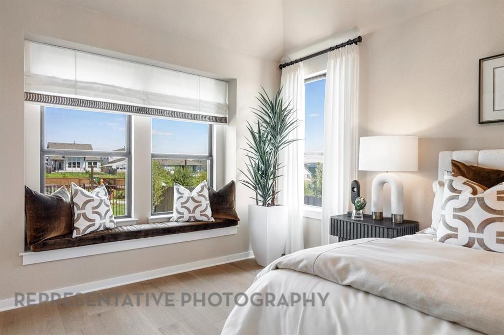 2132 Nerello Way Rockwall, TX 75032 - Photo 18 of 40 a bedroom with a large bed and a large window with balcony view