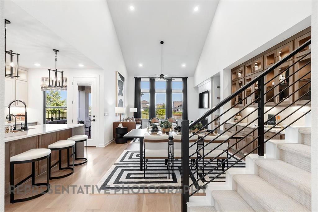 2132 Nerello Way Rockwall, TX 75032 - Photo 9 of 40 a large room with lots of white furniture and a chandelier