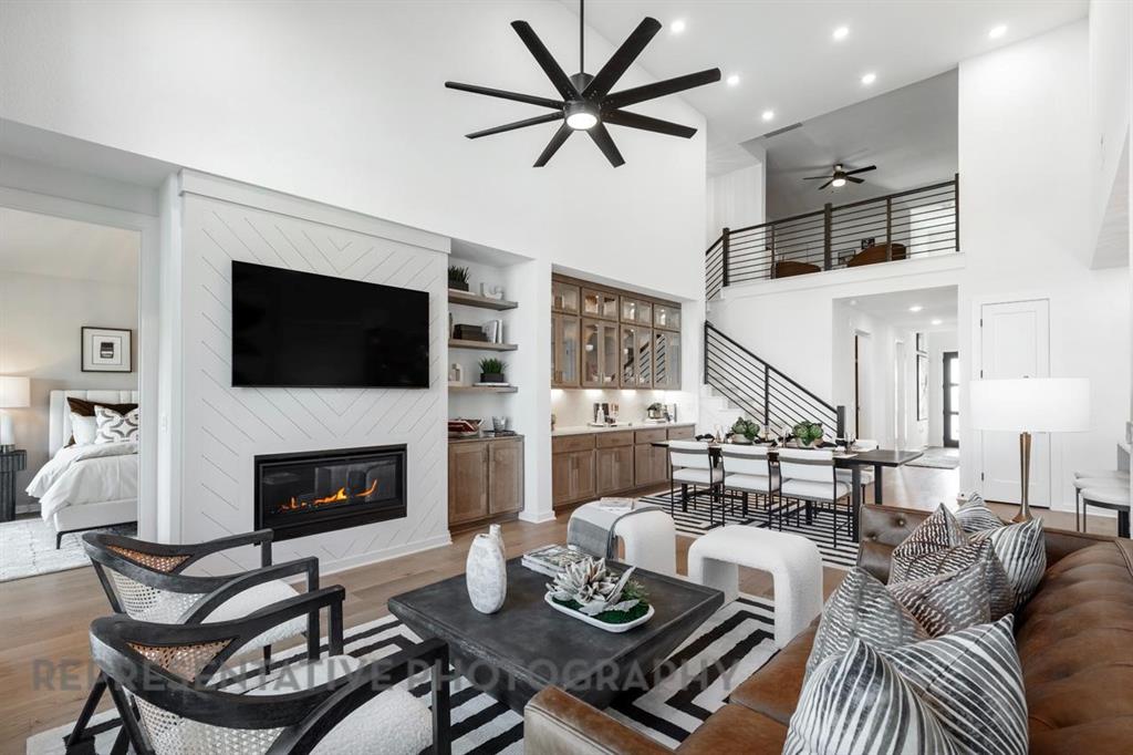 2132 Nerello Way Rockwall, TX 75032 - Photo 10 of 40 a living room with furniture a fireplace and a flat screen tv