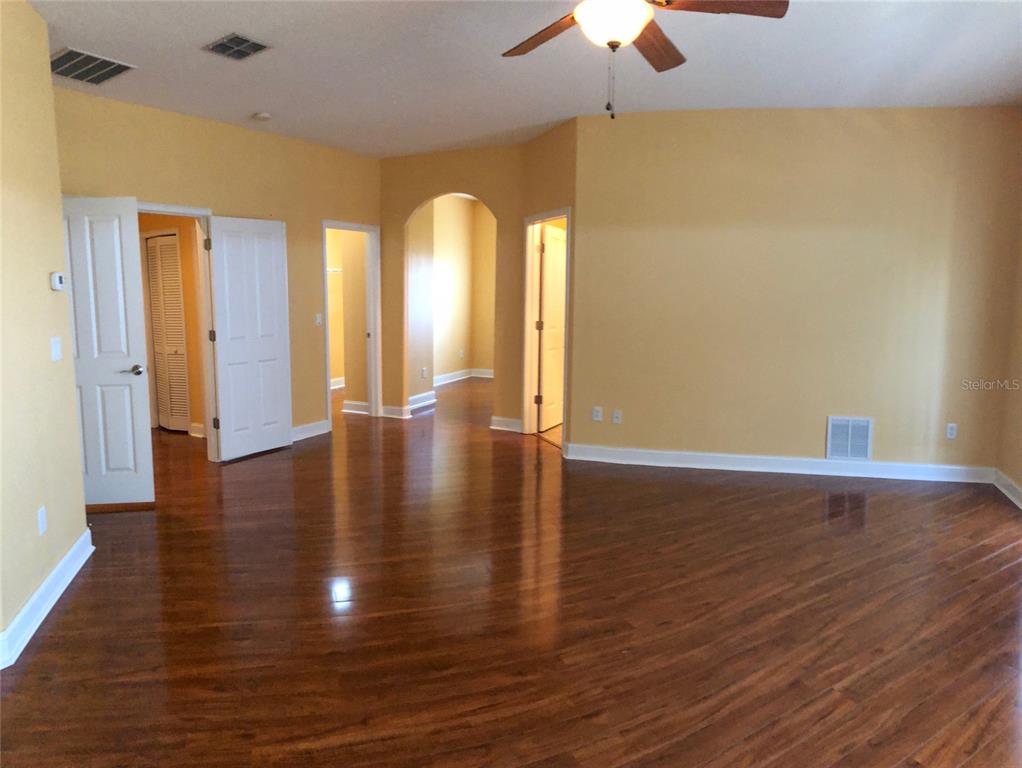 6517 Channelside Drive New Port Richey, FL 34652 - Photo 16 of 31 a view of an empty room with window and wooden floor