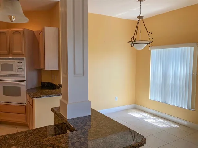 a kitchen that has a microwave a sink and a refrigerator