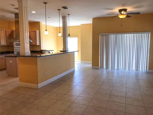 a kitchen with stainless steel appliances granite countertop a refrigerator a sink and a stove