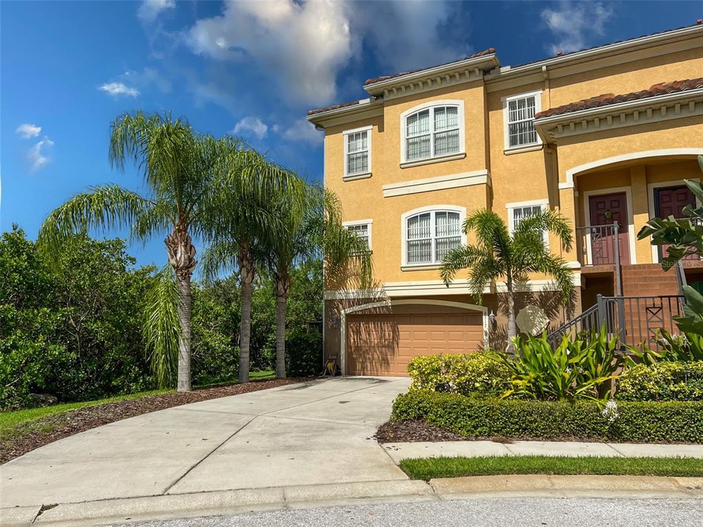 6517 Channelside Drive New Port Richey, FL 34652 - Photo 2 of 31 a front view of a house with garden