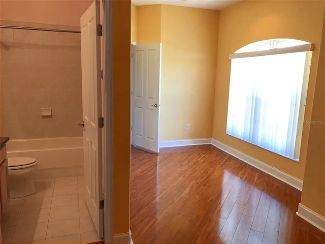 a bathroom with a granite countertop shower and a toilet