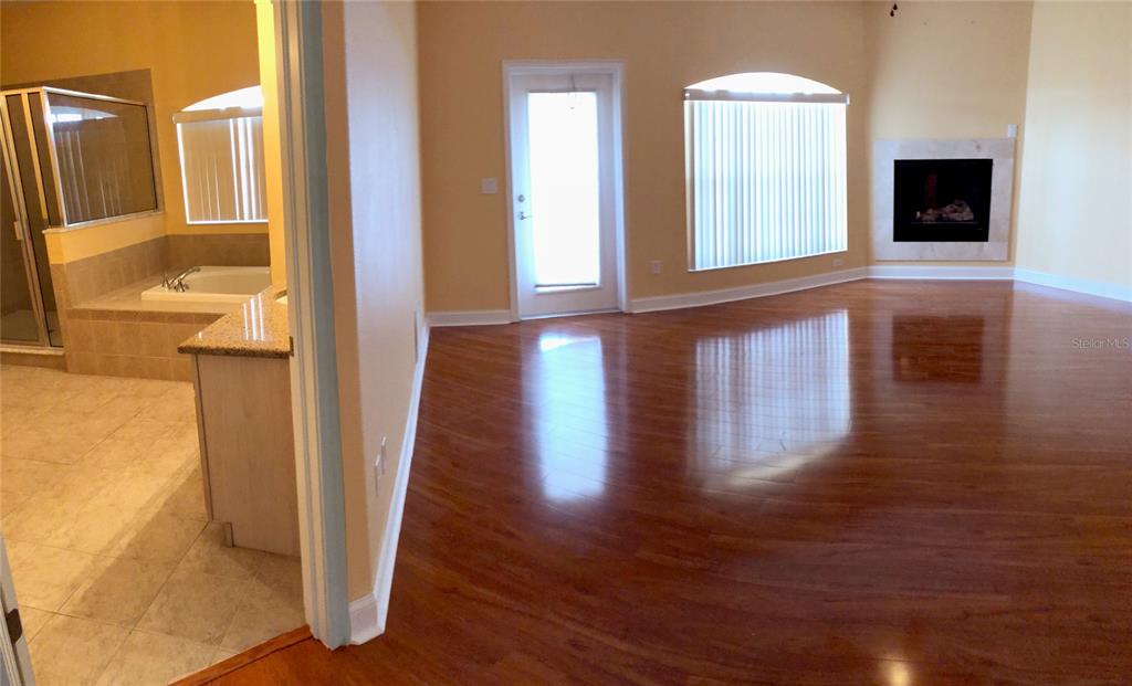 6517 Channelside Drive New Port Richey, FL 34652 - Photo 7 of 31 a view of an entryway with wooden floor and a fireplace