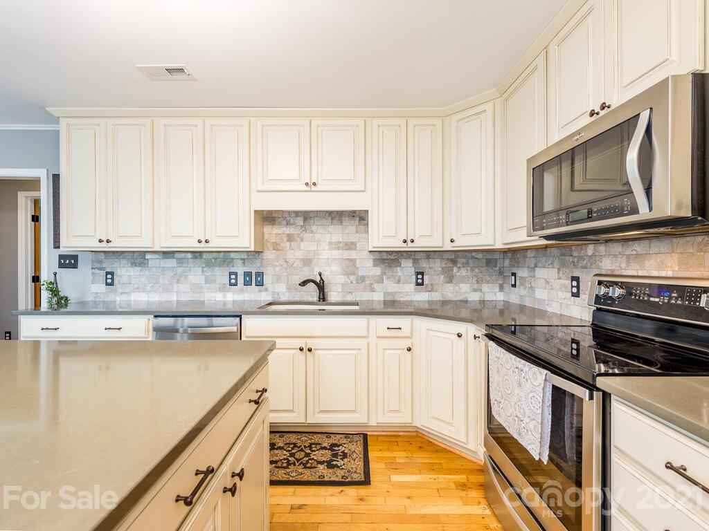 595 Hunters Ridge Road, Unit 20 Canton, NC 28716 - Photo 11 of 47 a kitchen with stainless steel appliances granite countertop a stove a sink and a microwave