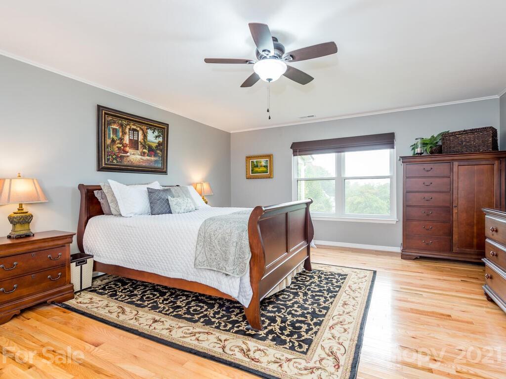 595 Hunters Ridge Road, Unit 20 Canton, NC 28716 - Photo 13 of 47 a bedroom with a bed lamp and a dresser