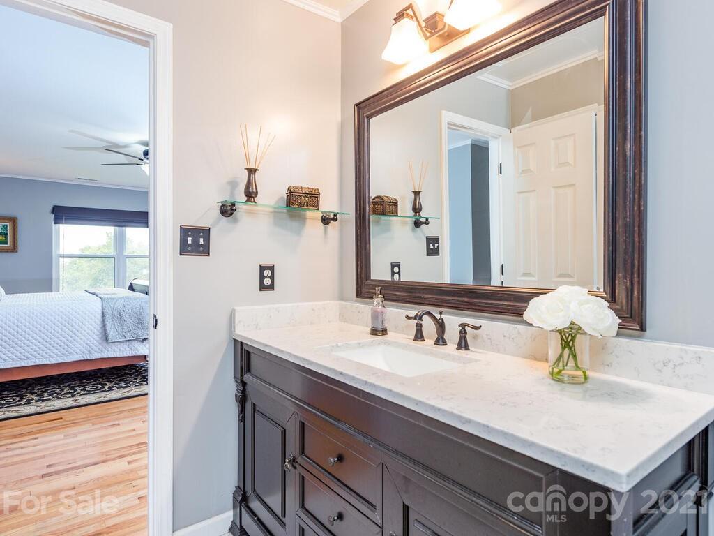 595 Hunters Ridge Road, Unit 20 Canton, NC 28716 - Photo 18 of 47 a en suite bathroom with a sink and a mirror