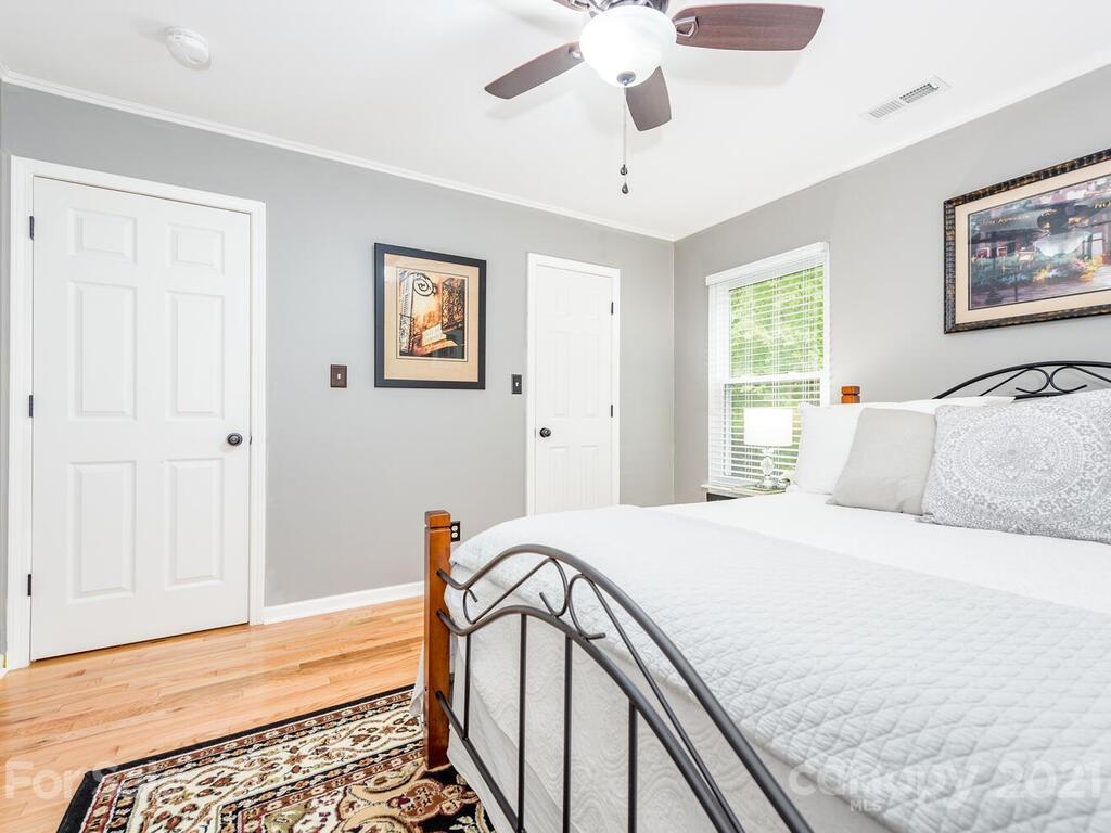 595 Hunters Ridge Road, Unit 20 Canton, NC 28716 - Photo 24 of 47 a bedroom with a bed and a chandelier