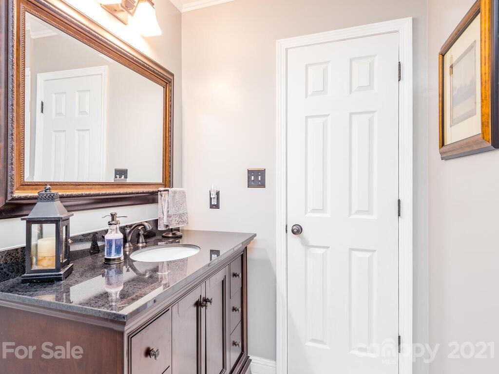 595 Hunters Ridge Road, Unit 20 Canton, NC 28716 - Photo 29 of 47 a bathroom with a granite countertop sink and a mirror