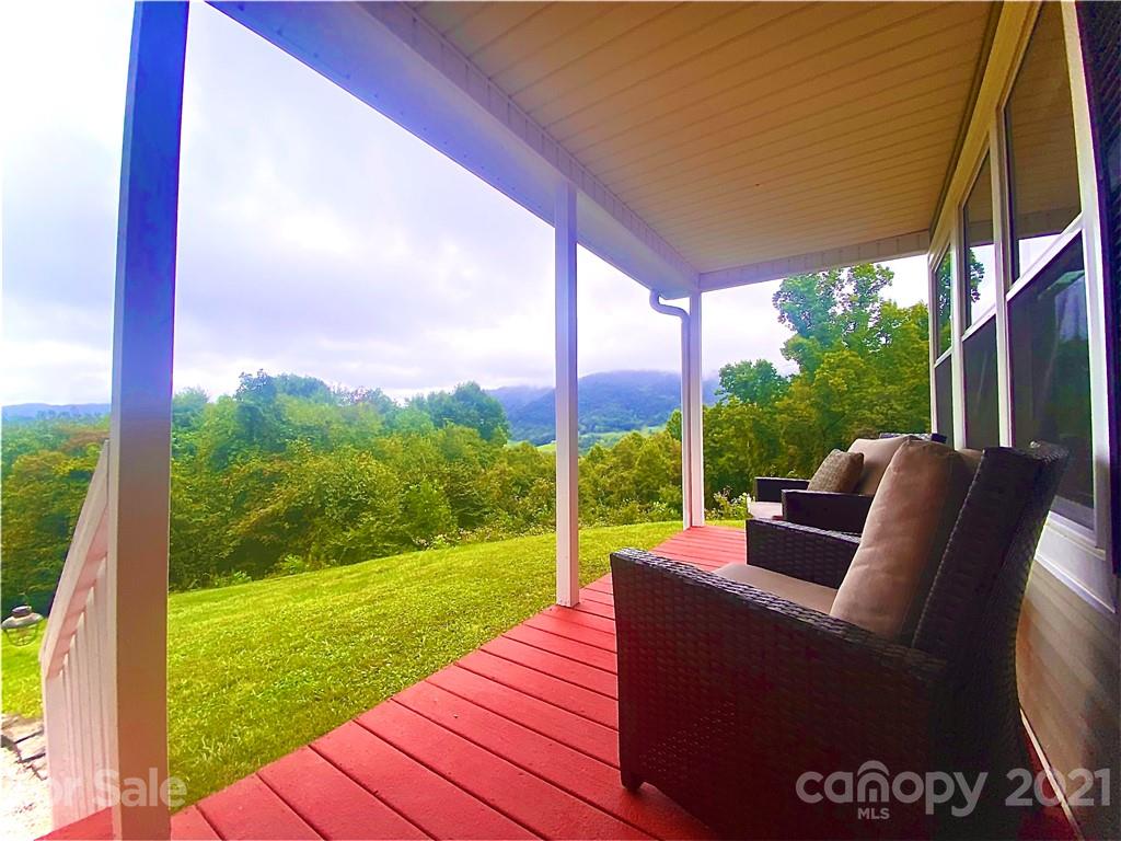 595 Hunters Ridge Road, Unit 20 Canton, NC 28716 - Photo 39 of 47 a view of a patio with a table chairs and a backyard