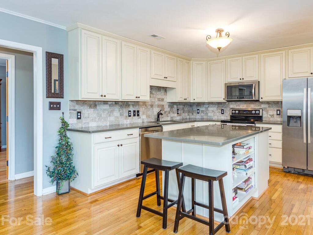 595 Hunters Ridge Road, Unit 20 Canton, NC 28716 - Photo 10 of 47 a kitchen with a refrigerator cabinets and wooden floor
