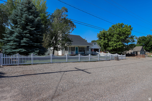 270 East 100 North Monroe, UT 84754 - Photo 8 of 65 White picket fence enclosing a landscaped front yard with a mature evergreen tree