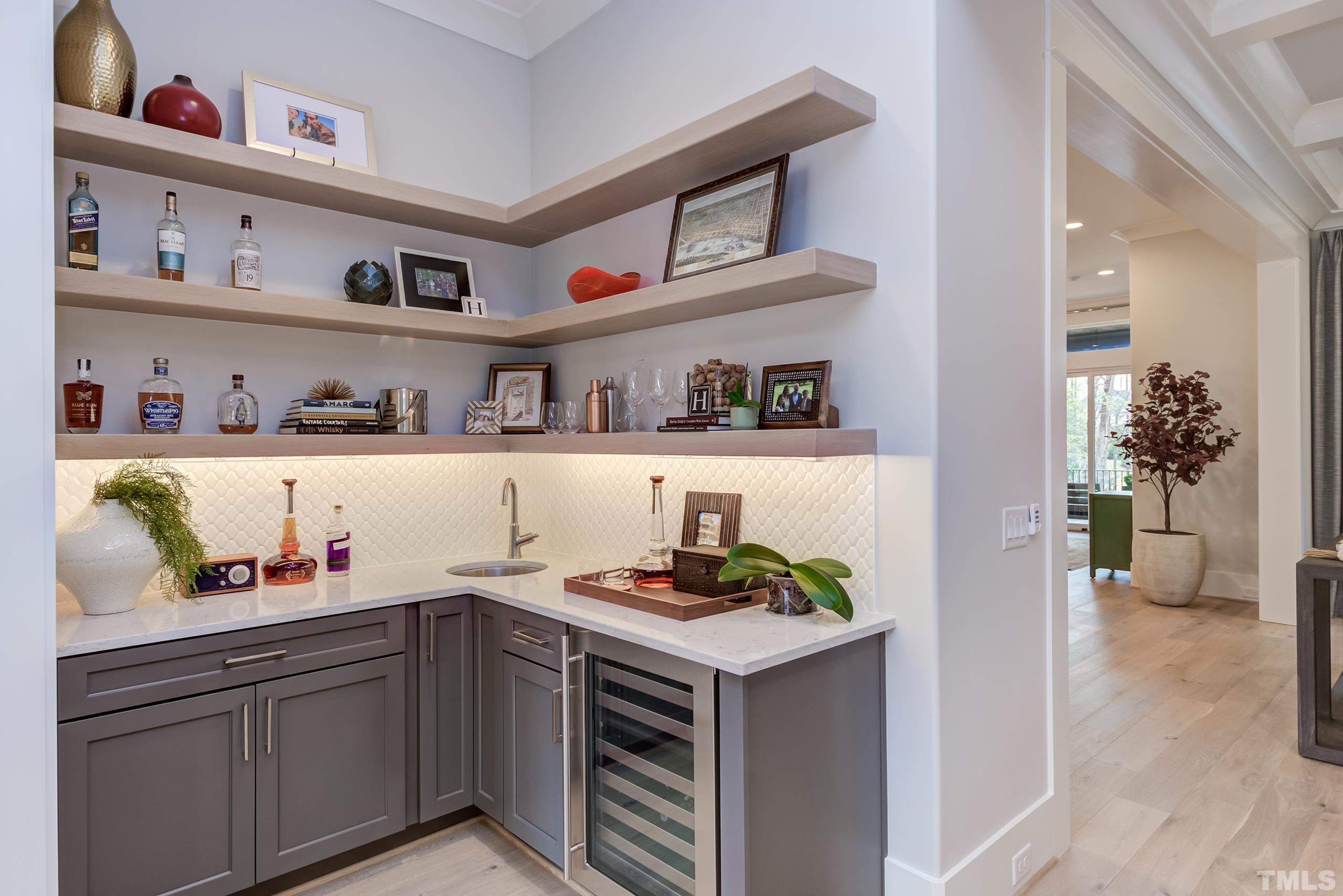 5112 Winding View Lane Raleigh, NC 27615 - Photo 11 of 71 a kitchen with stainless steel appliances granite countertop a shelf with cabinets and wooden floor