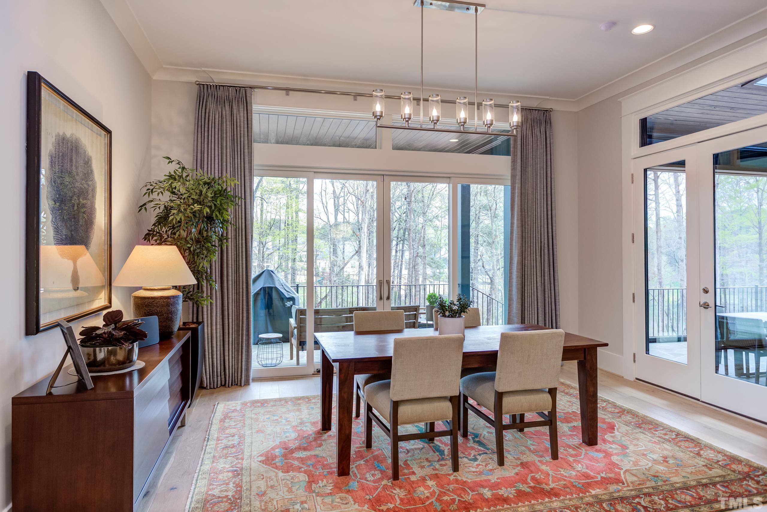 5112 Winding View Lane Raleigh, NC 27615 - Photo 25 of 71 a view of a dining room with furniture a chandelier and large window