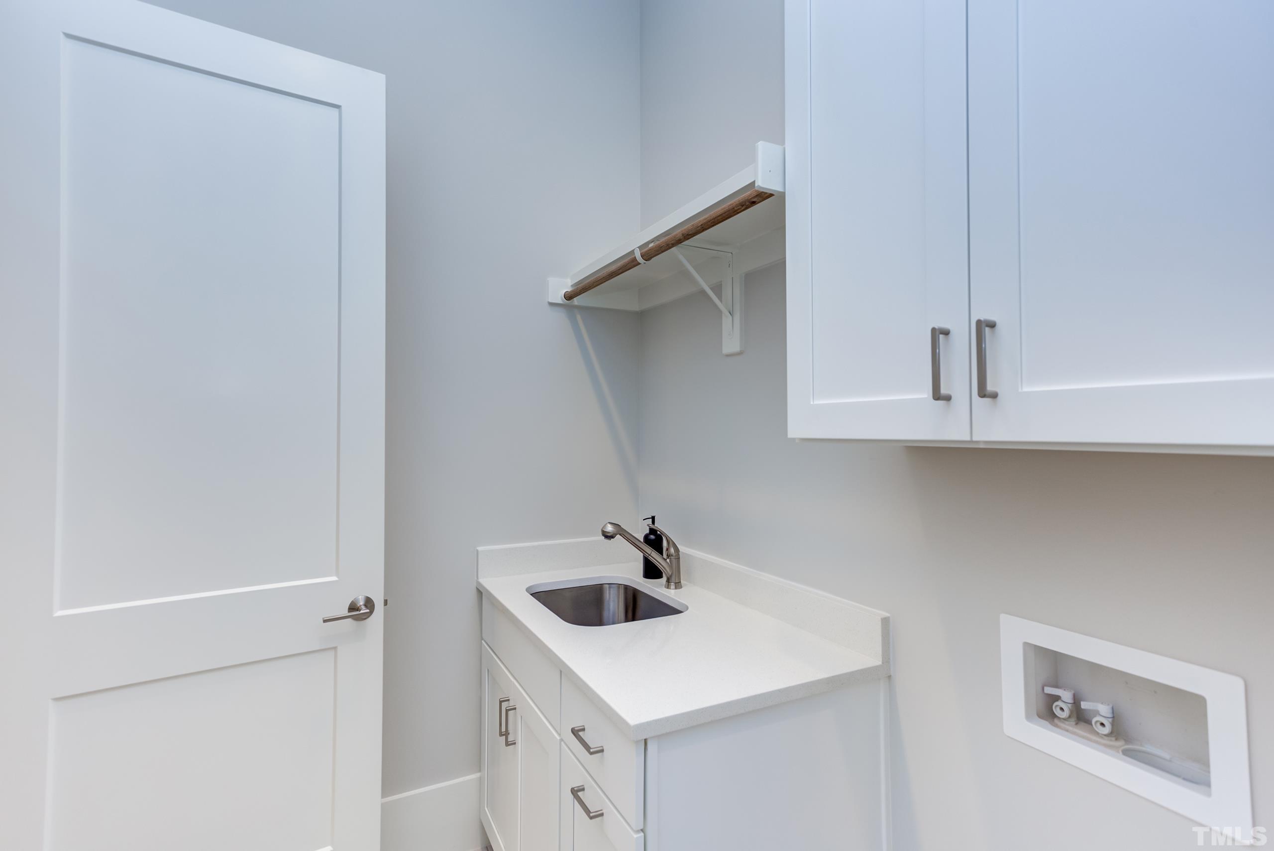 5112 Winding View Lane Raleigh, NC 27615 - Photo 30 of 71 a kitchen with a sink a refrigerator and cabinets