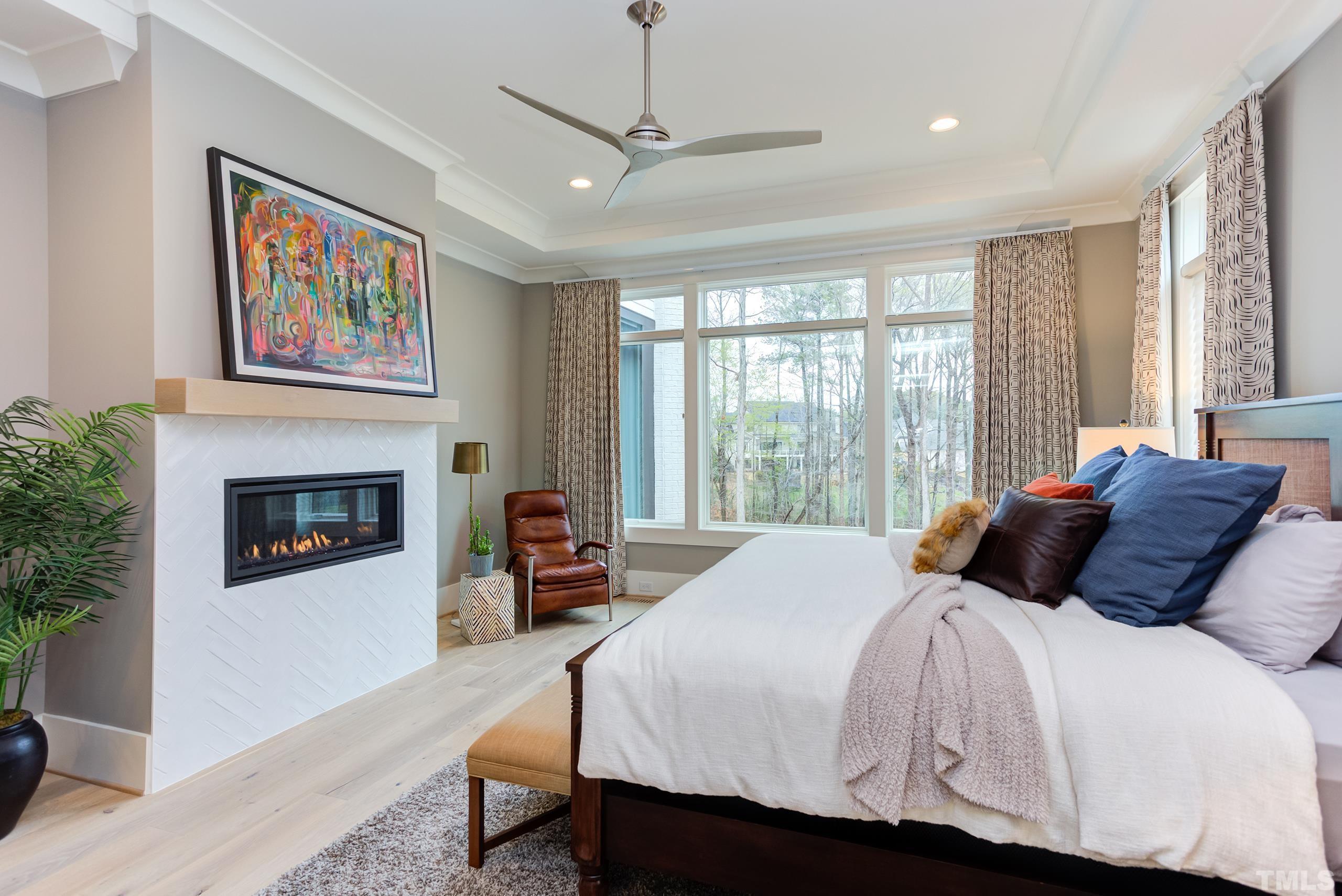 5112 Winding View Lane Raleigh, NC 27615 - Photo 32 of 71 a bedroom with a large bed and a fireplace