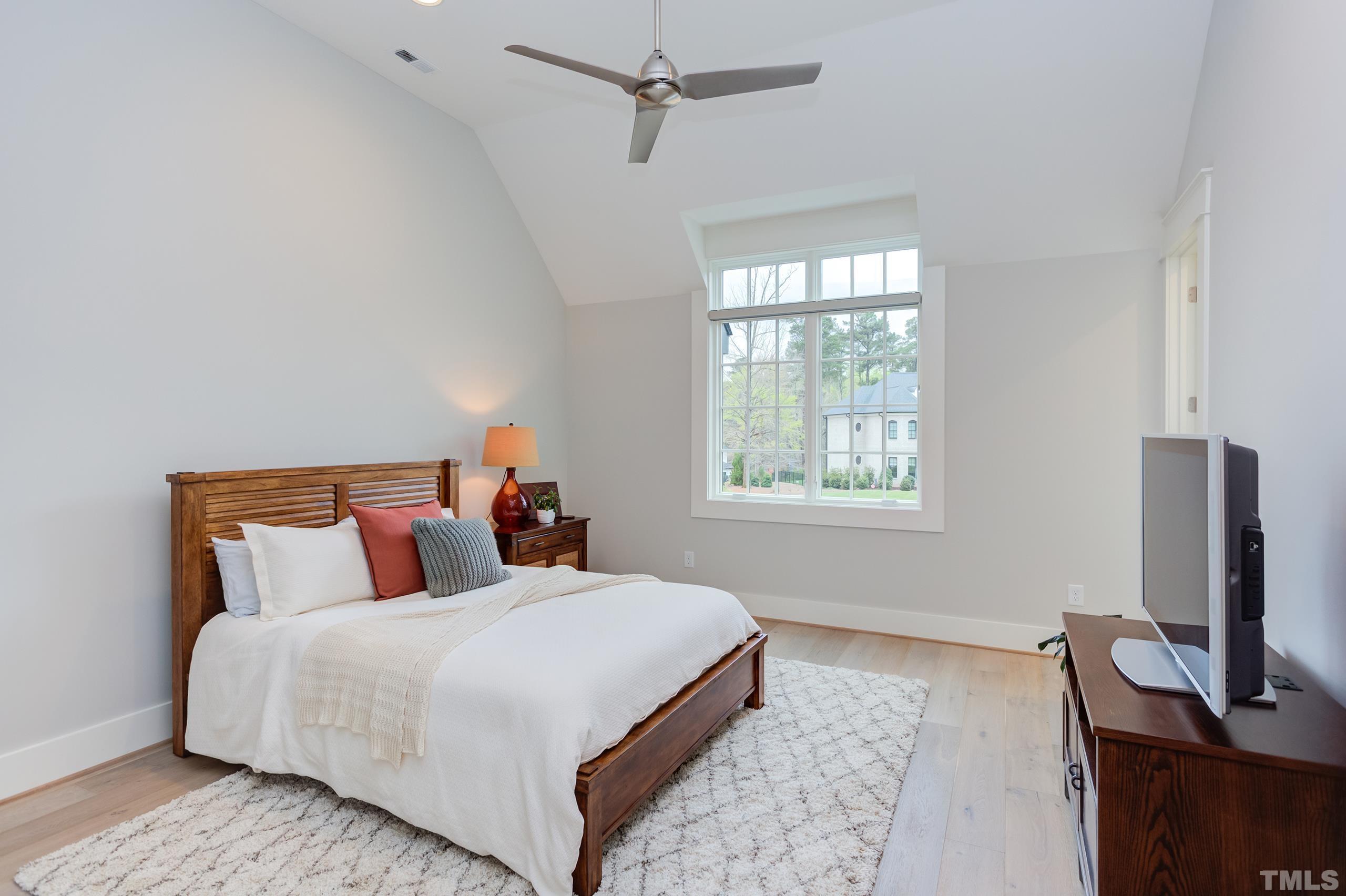 5112 Winding View Lane Raleigh, NC 27615 - Photo 48 of 71 a bedroom with a bed and a flat screen tv