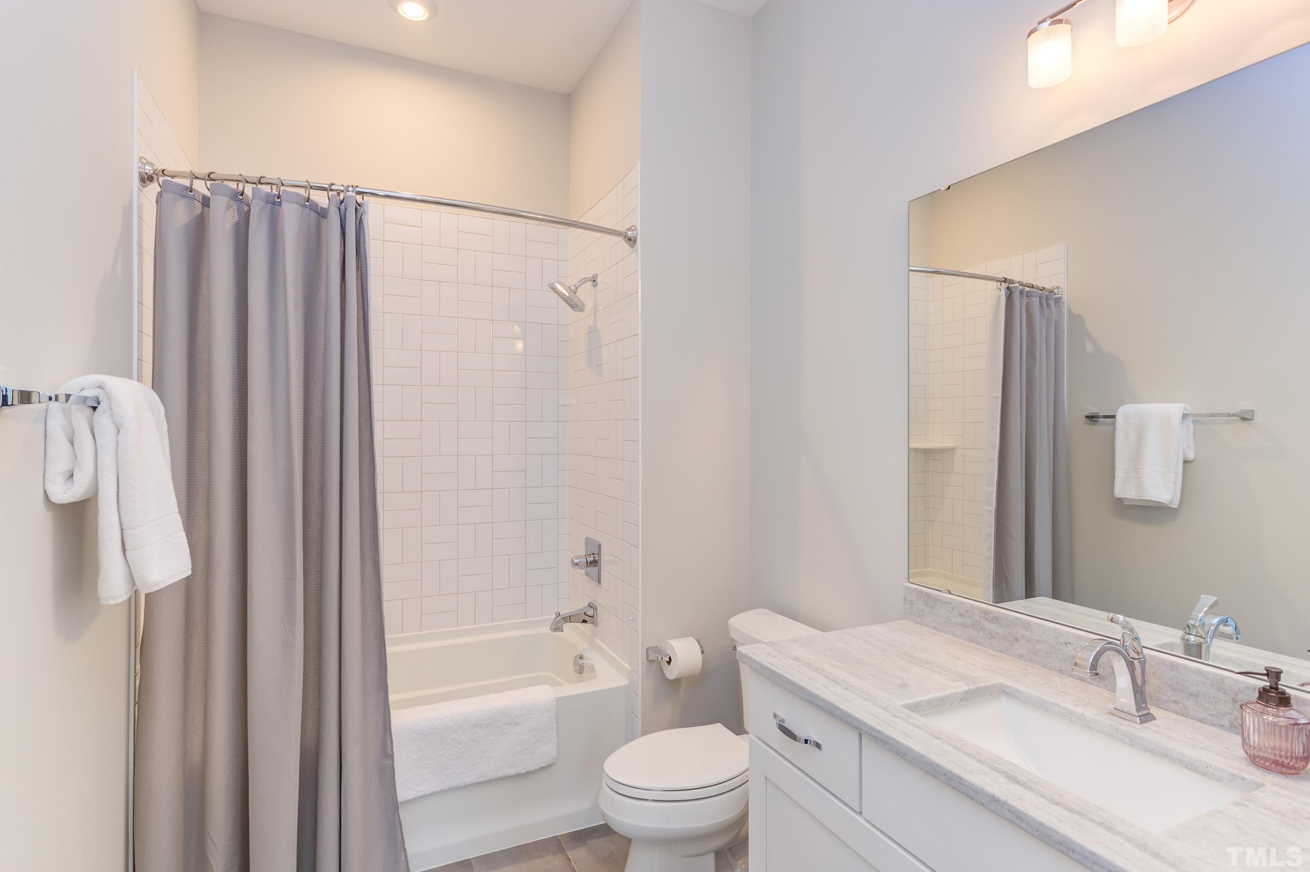 5112 Winding View Lane Raleigh, NC 27615 - Photo 53 of 71 a bathroom with a granite countertop sink toilet and shower