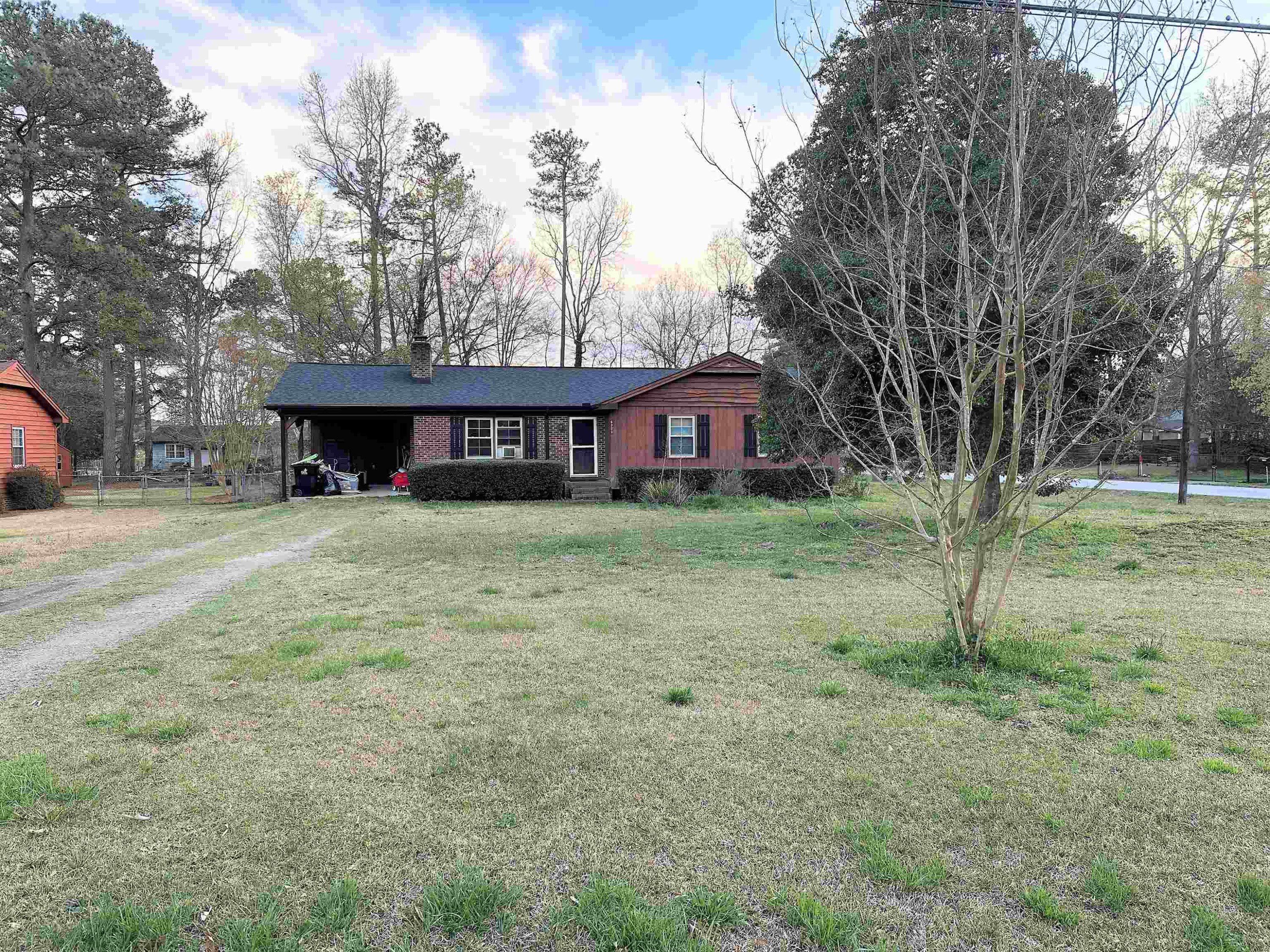 a view of a house with a yard and trees