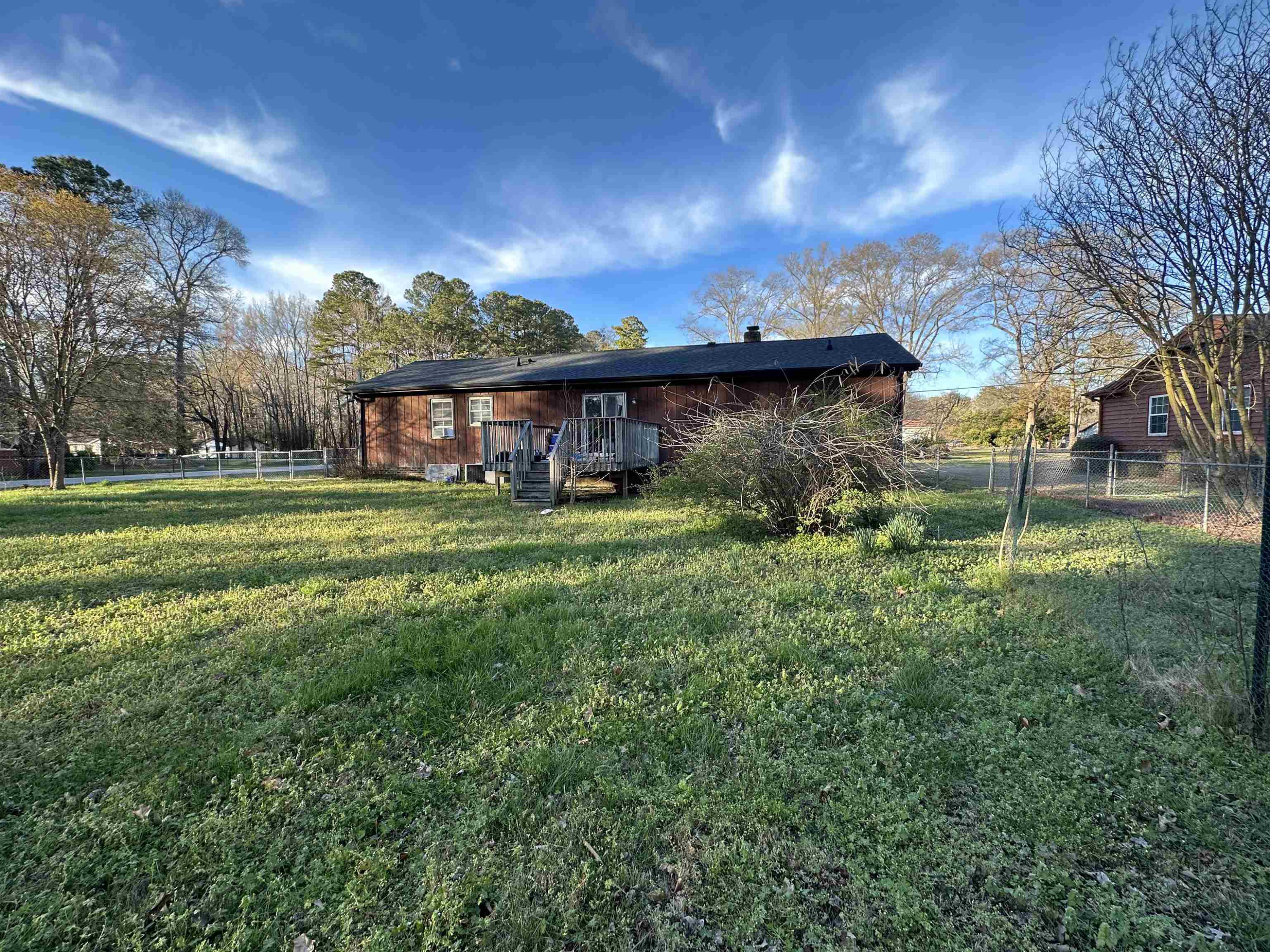 6000 Neuse Street Raleigh, NC 27610 - Photo 2 of 13 a view of a house with a big yard and large trees