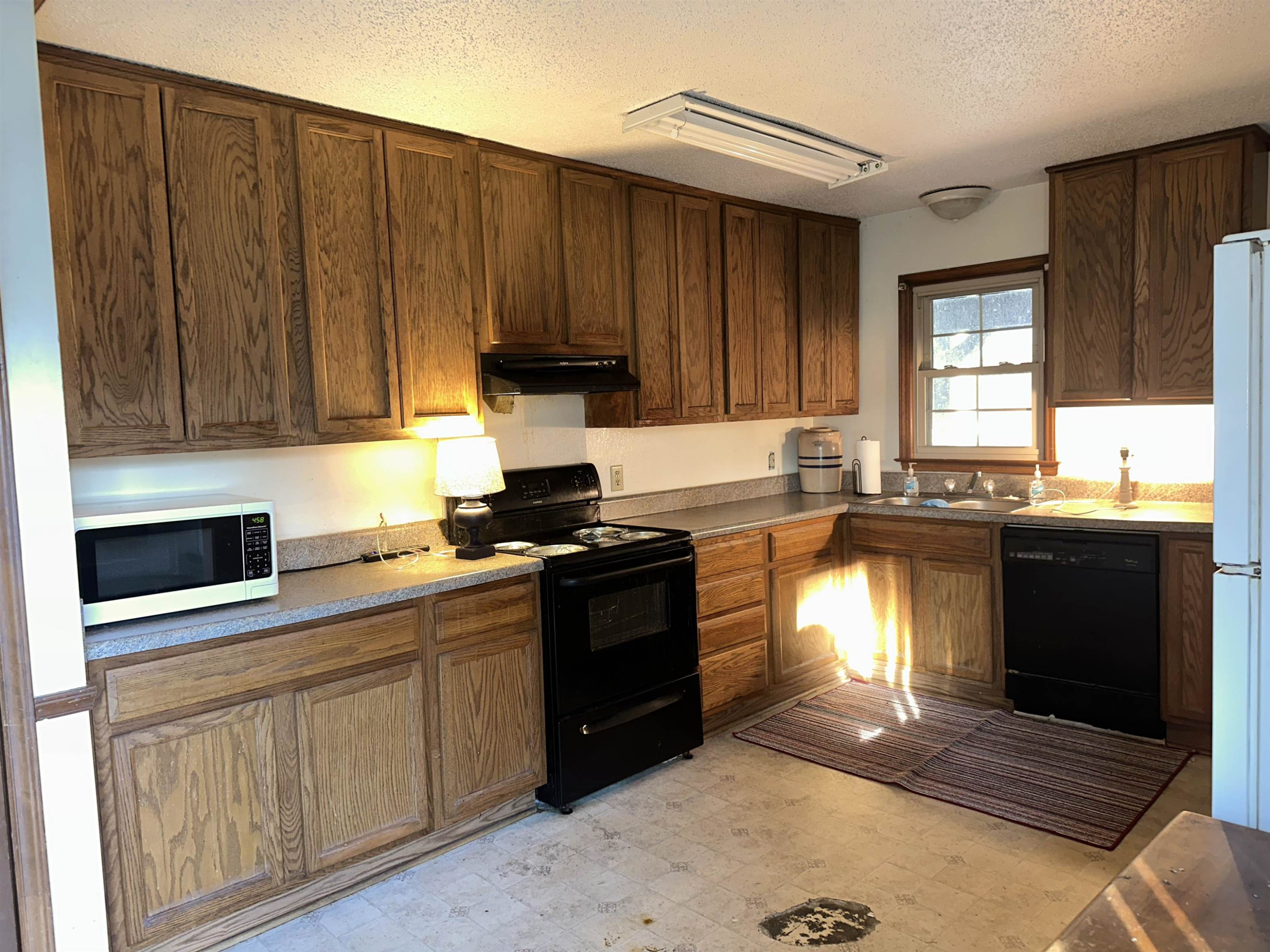 6000 Neuse Street Raleigh, NC 27610 - Photo 5 of 13 a kitchen with stainless steel appliances granite countertop a stove a sink and a microwave