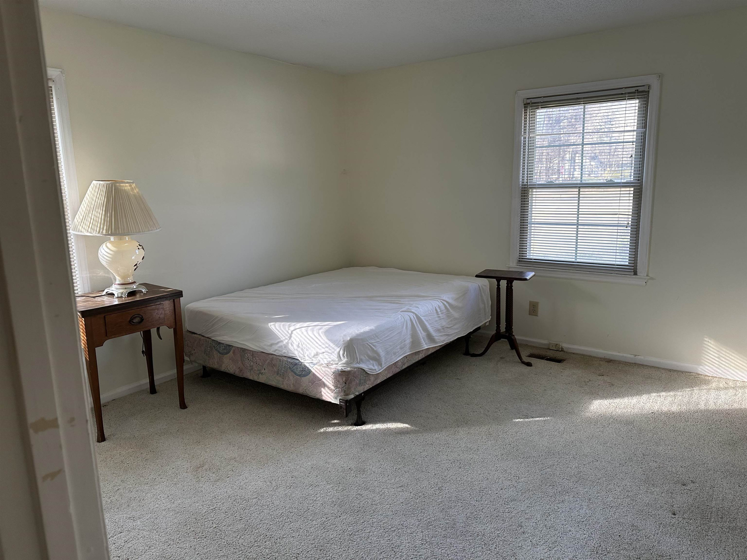 6000 Neuse Street Raleigh, NC 27610 - Photo 9 of 13 a bed sitting in a bedroom next to a window