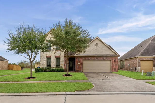 a front view of a house with a yard and garage
