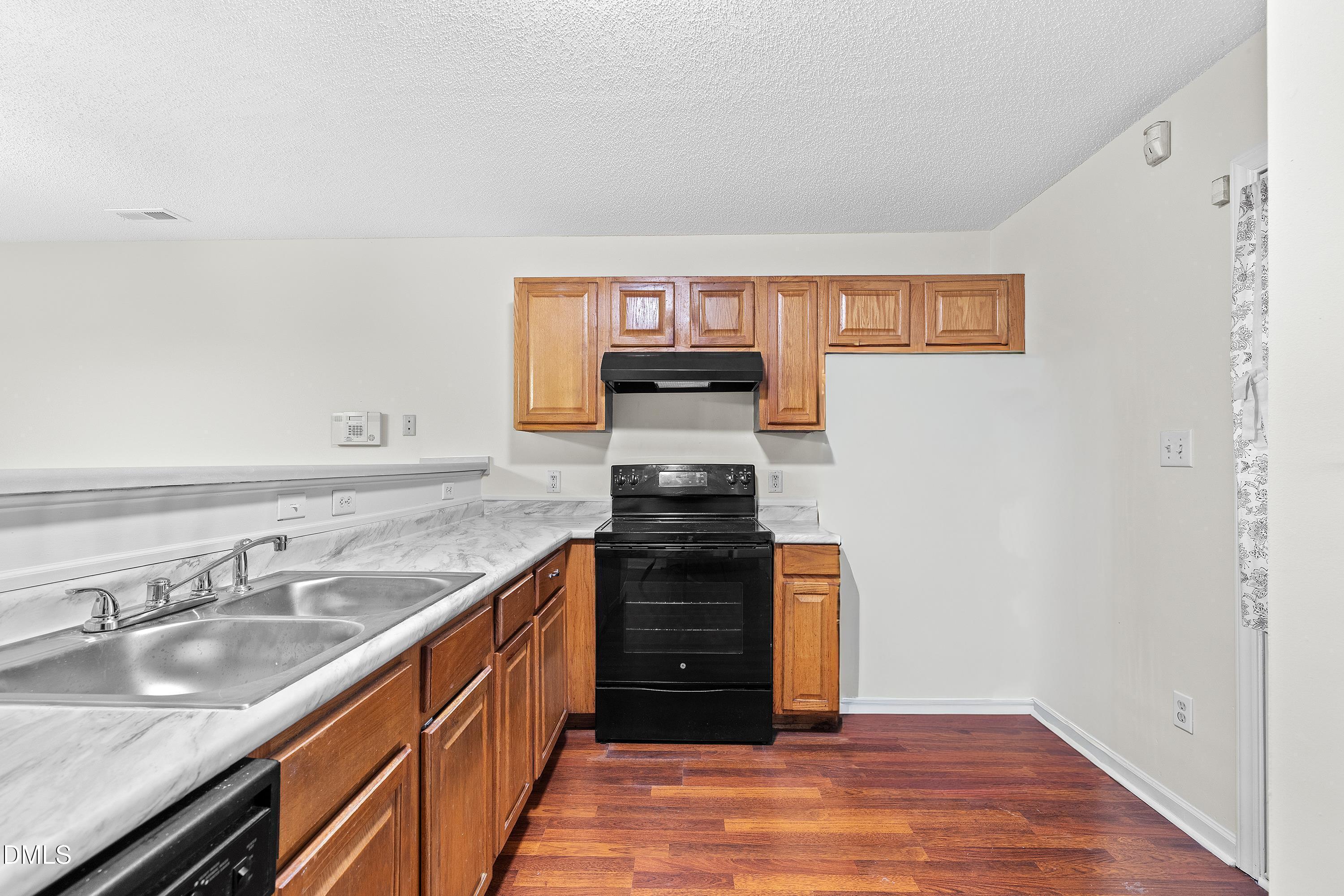 2241 Violet Bluff Court Raleigh, NC 27610 - Photo 10 of 28 a kitchen with granite countertop a stove top oven and sink