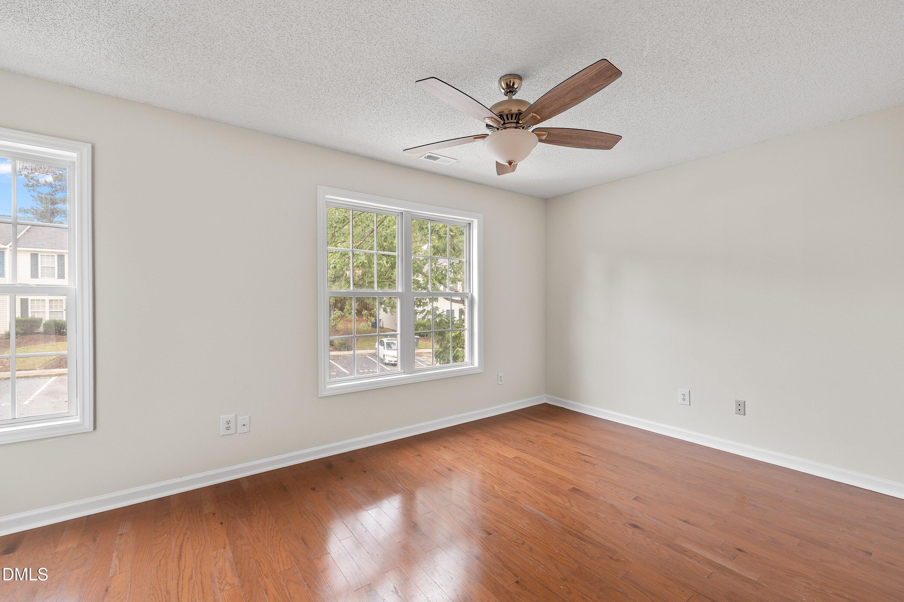2241 Violet Bluff Court Raleigh, NC 27610 - Photo 14 of 28 a view of an empty room with wooden floor and a window