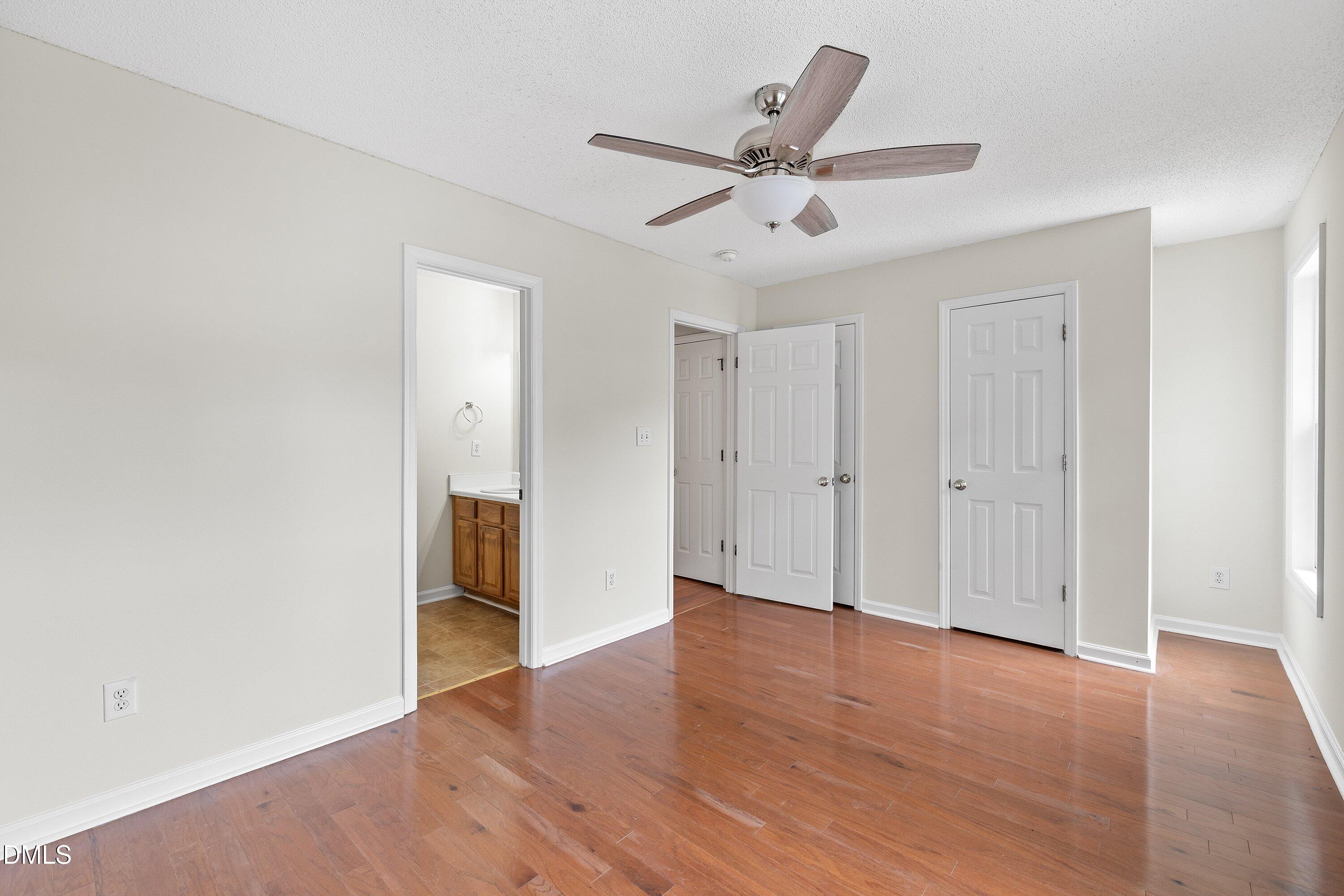 2241 Violet Bluff Court Raleigh, NC 27610 - Photo 16 of 28 an empty room with wooden floor fan and windows