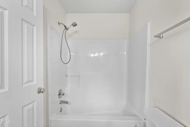 a bathroom with double vanity sinks and a mirror