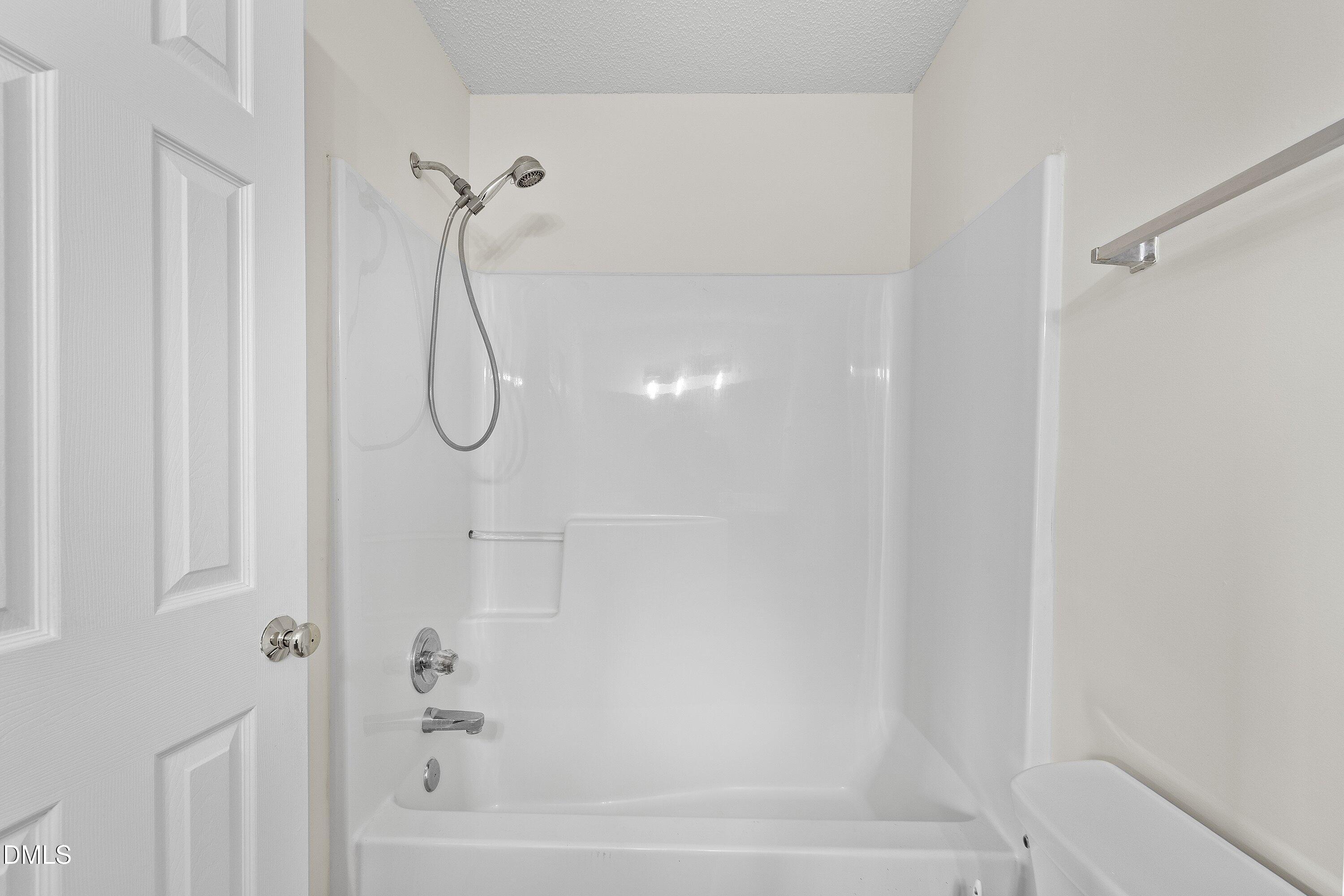 2241 Violet Bluff Court Raleigh, NC 27610 - Photo 19 of 28 a bathroom with a glass shower door