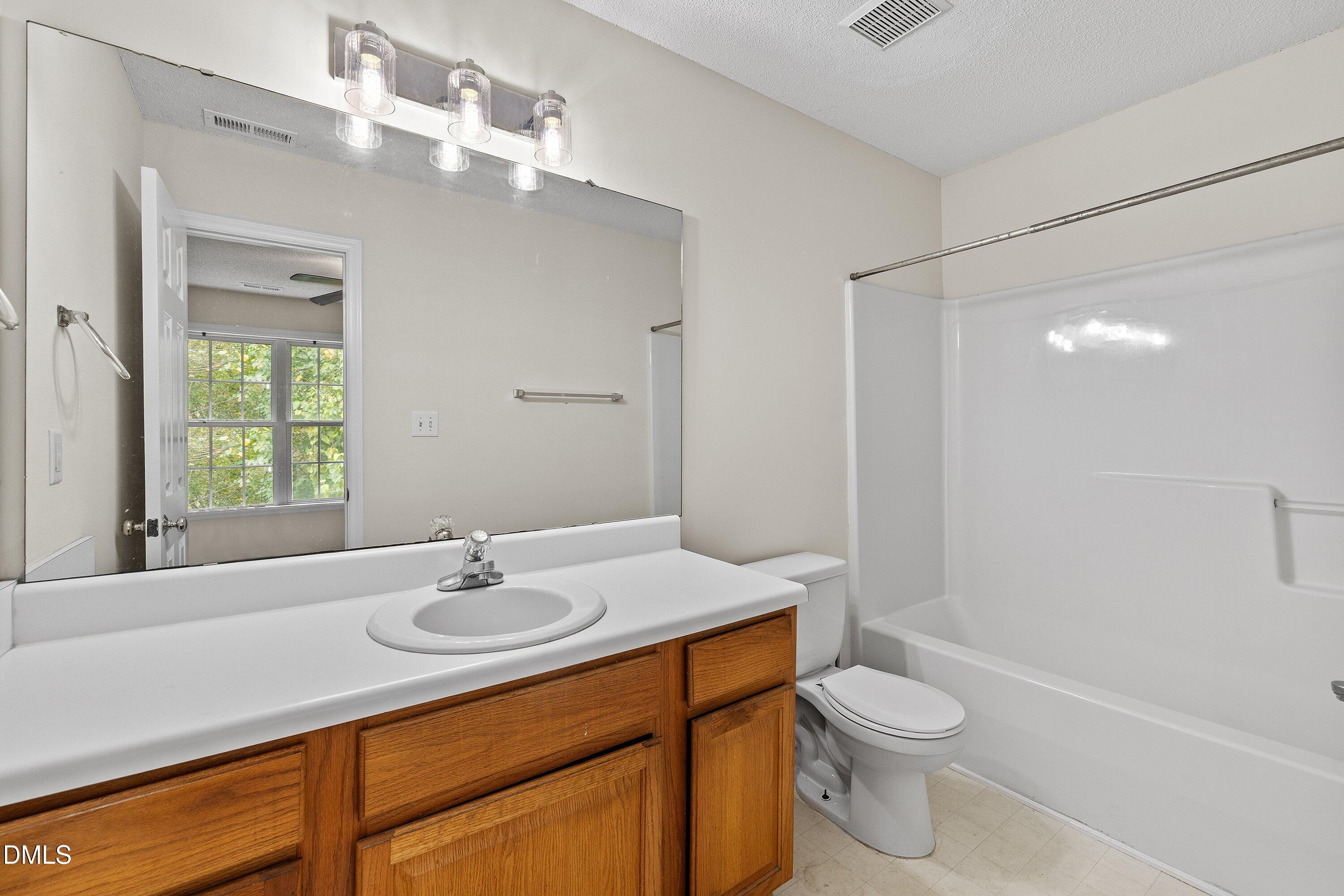 2241 Violet Bluff Court Raleigh, NC 27610 - Photo 23 of 28 a bathroom with a sink toilet and shower