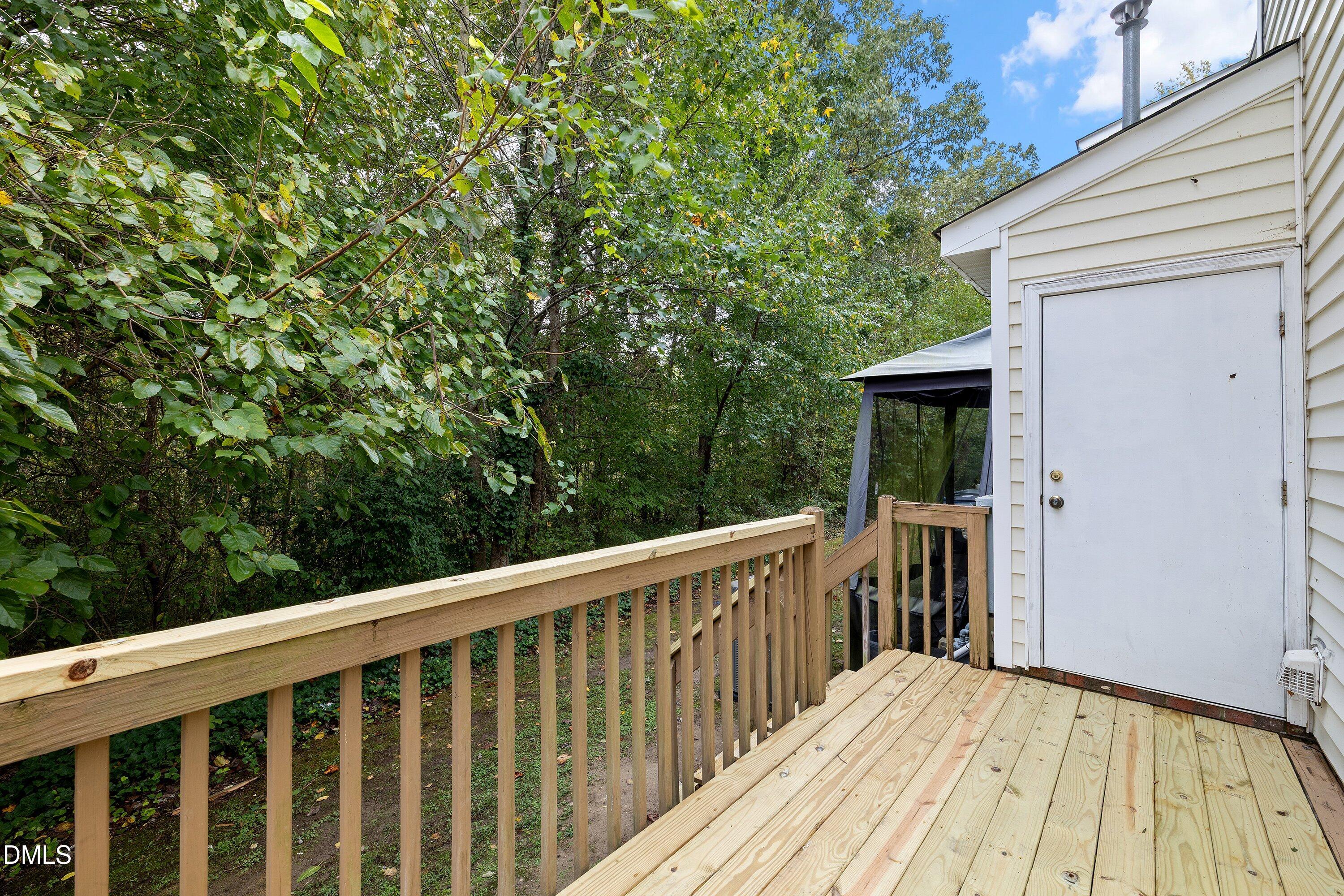 2241 Violet Bluff Court Raleigh, NC 27610 - Photo 24 of 28 a balcony with wooden floor and fence