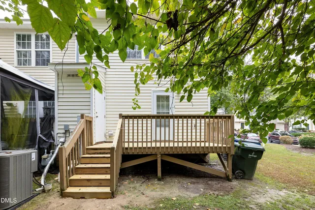 a view of a chair and table in the back yard