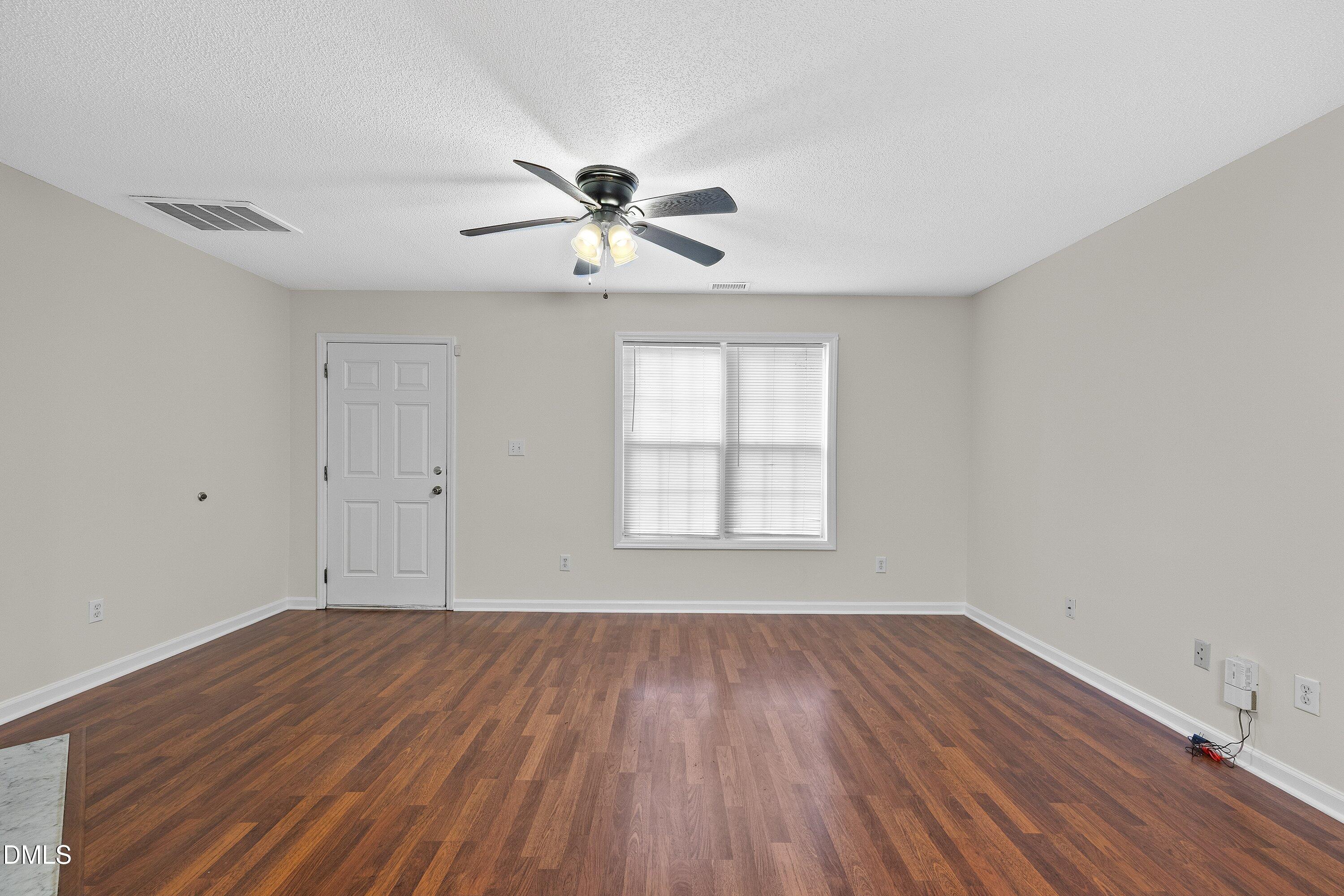 2241 Violet Bluff Court Raleigh, NC 27610 - Photo 7 of 28 a view of empty room with wooden floor and fan