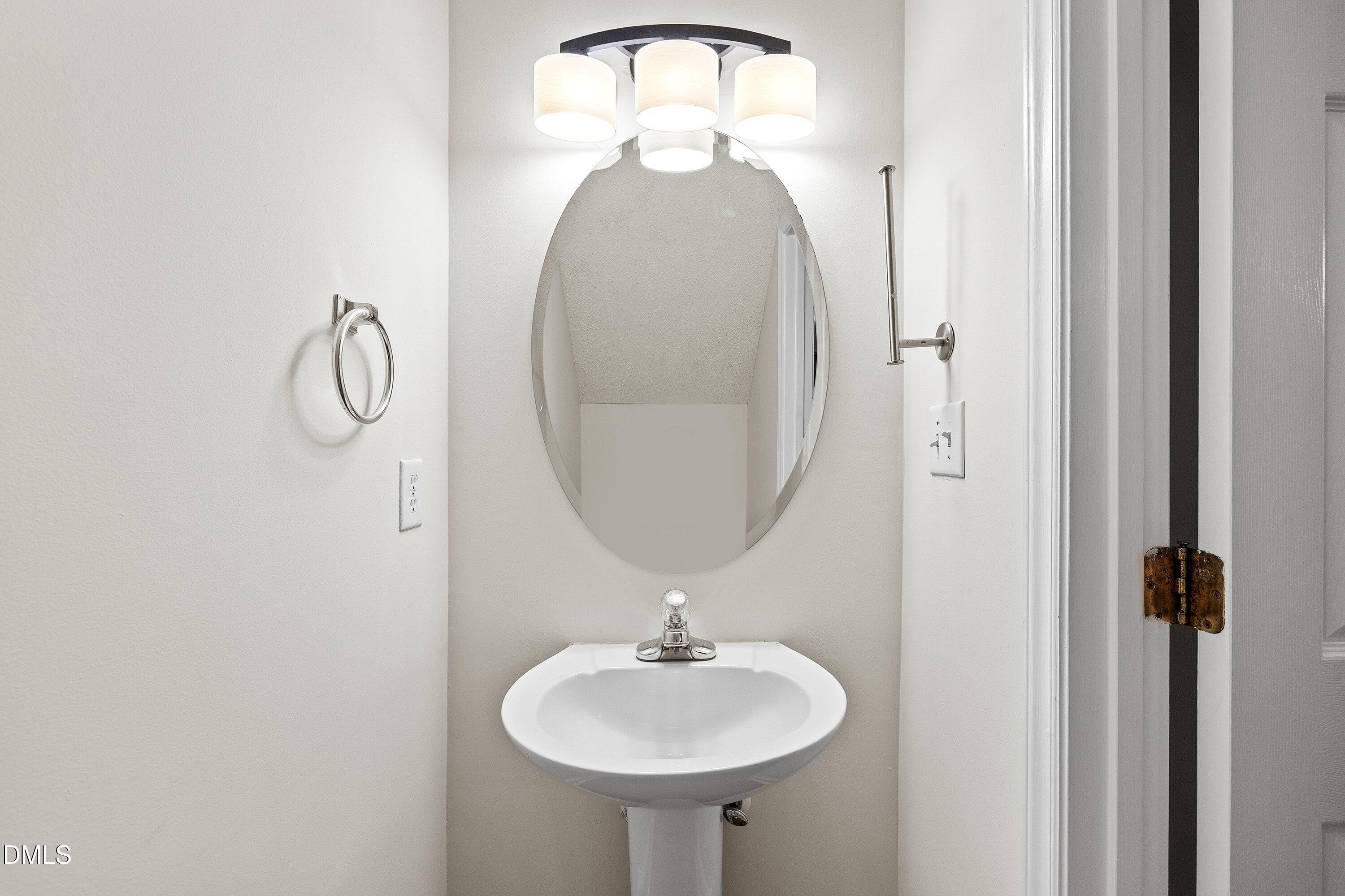 2241 Violet Bluff Court Raleigh, NC 27610 - Photo 8 of 28 a bathroom with a sink and a mirror