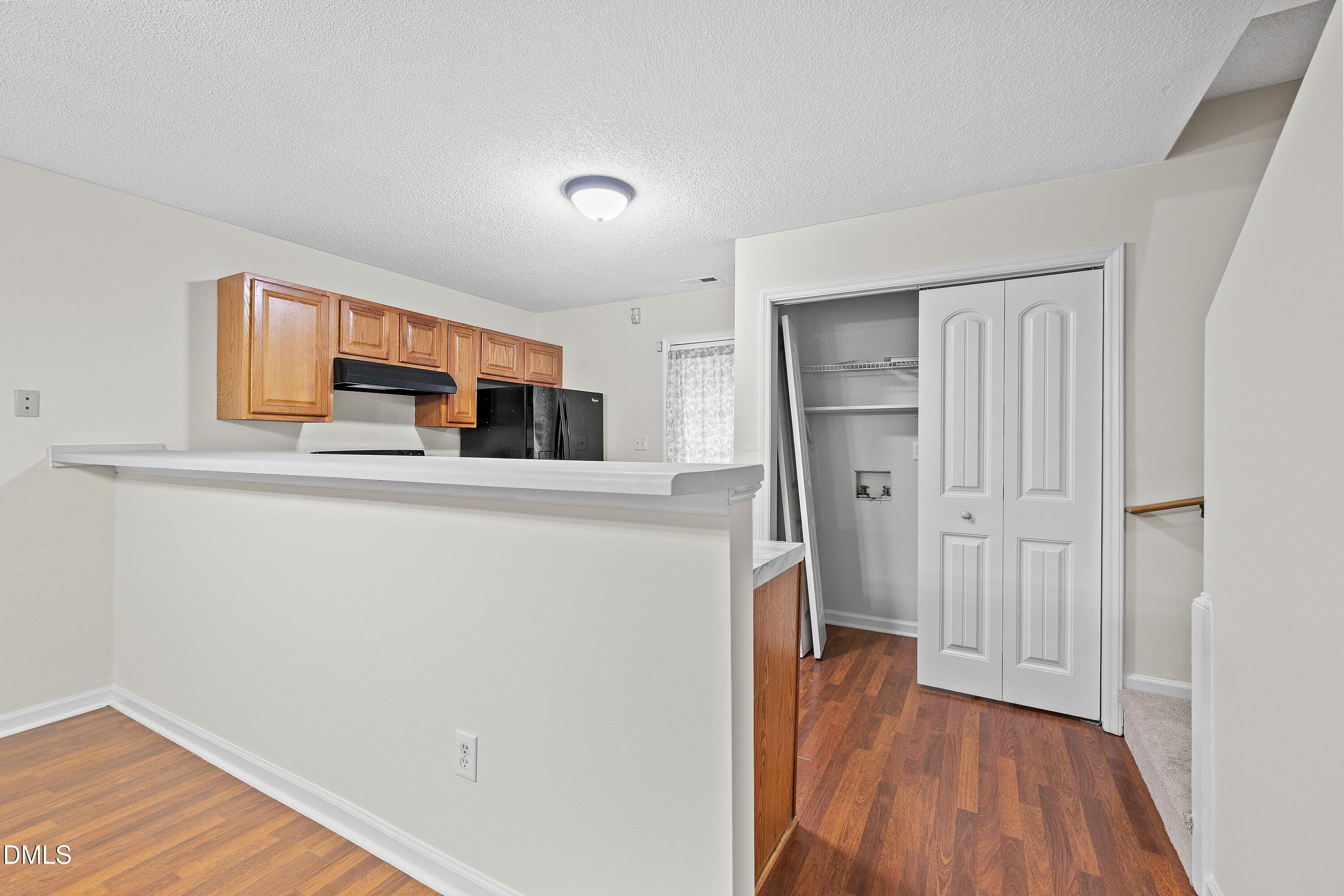 2241 Violet Bluff Court Raleigh, NC 27610 - Photo 9 of 28 a kitchen with stainless steel appliances a refrigerator and a wooden floor