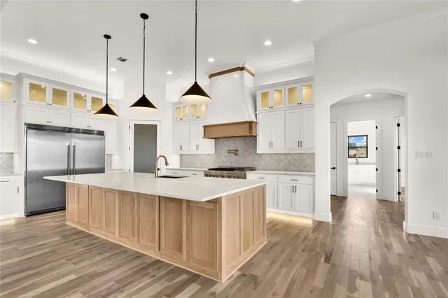 a large kitchen with stainless steel appliances kitchen island a large island in the center