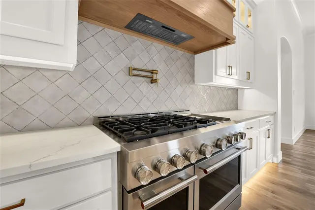 a stove top oven sitting inside of a kitchen