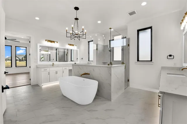 a large room with a lot of cabinets and chandelier