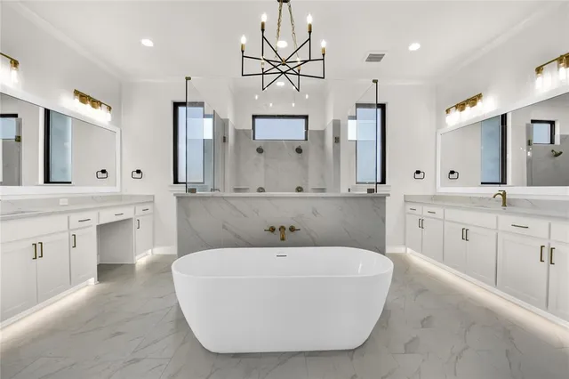 a bathroom with a tub a double vanity sink and a mirror