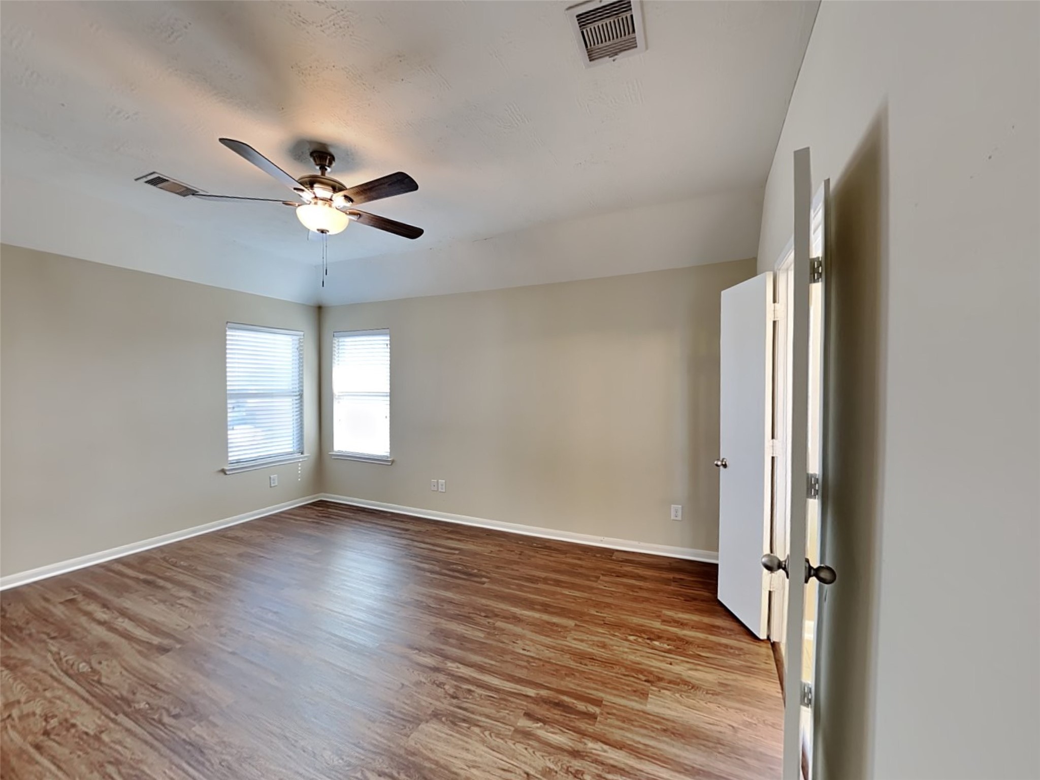 19022 Walbrook Meadows Lane Cypress, TX 77433 - Photo 13 of 23 an empty room with wooden floor fan and windows