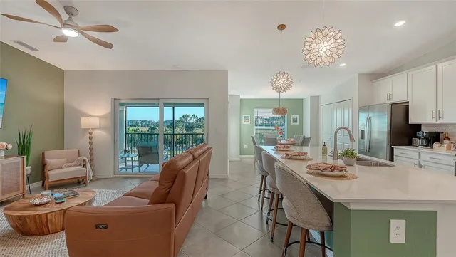 a living room with furniture and a floor to ceiling window