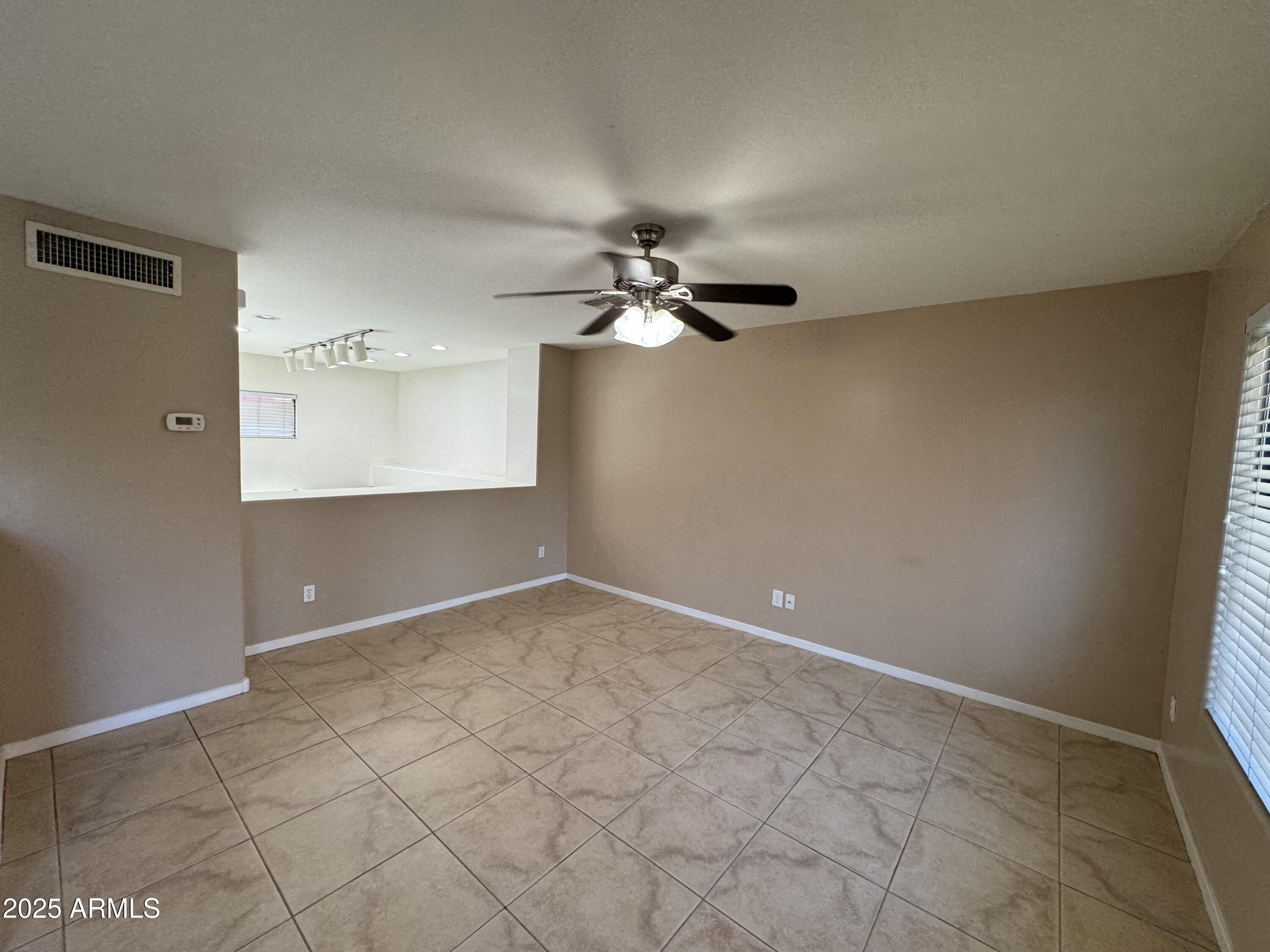 305 South Wilson Street, Unit 111 Tempe, AZ 85281 - Photo 6 of 48 a view of a room with a ceiling fan and wooden floor