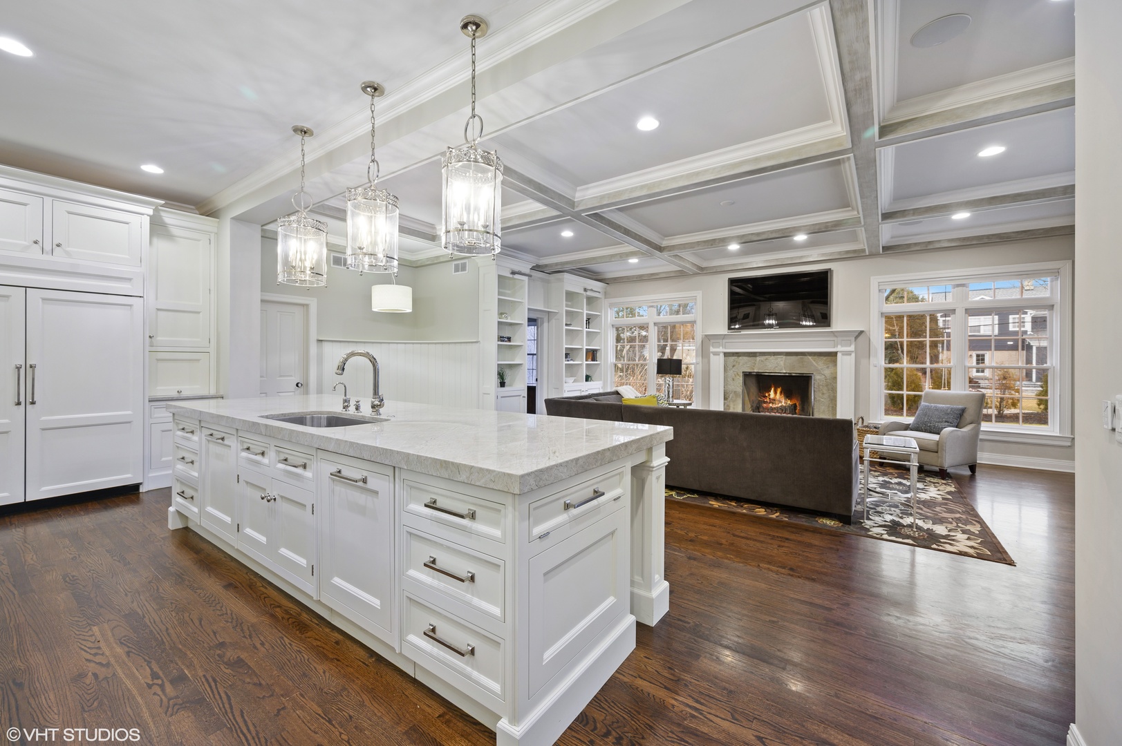 909 Windsor Road Glenview, IL 60025 - Photo 11 of 47 a kitchen with kitchen island granite countertop a sink cabinets and wooden floor
