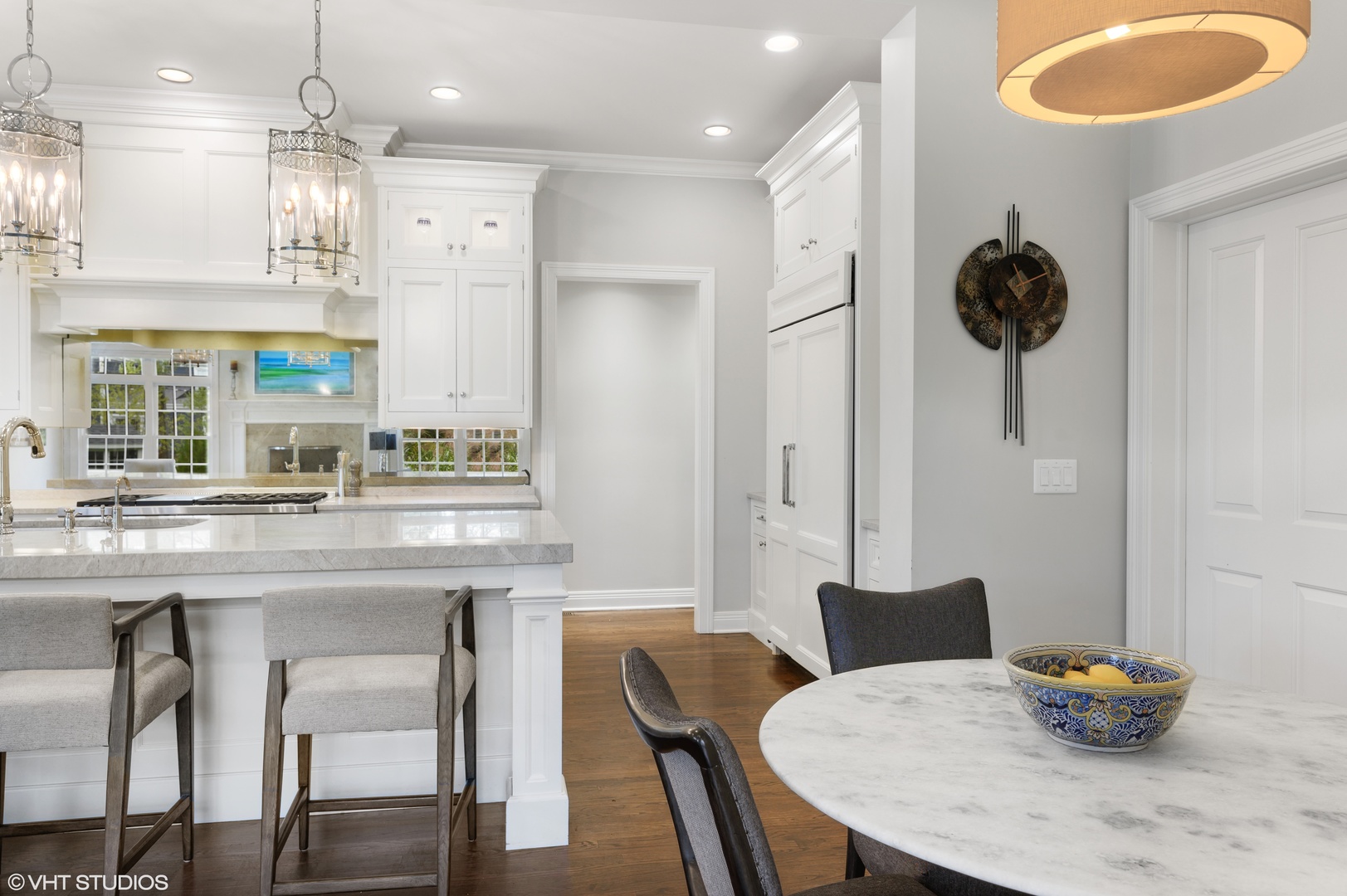 909 Windsor Road Glenview, IL 60025 - Photo 14 of 47 a kitchen with stainless steel appliances granite countertop a table chairs and a refrigerator