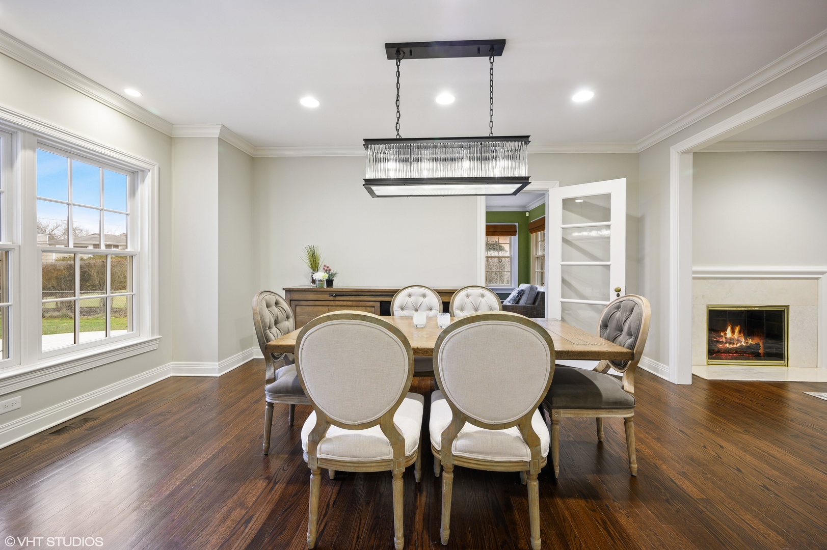 909 Windsor Road Glenview, IL 60025 - Photo 17 of 47 a dining room with furniture a fireplace and wooden floor