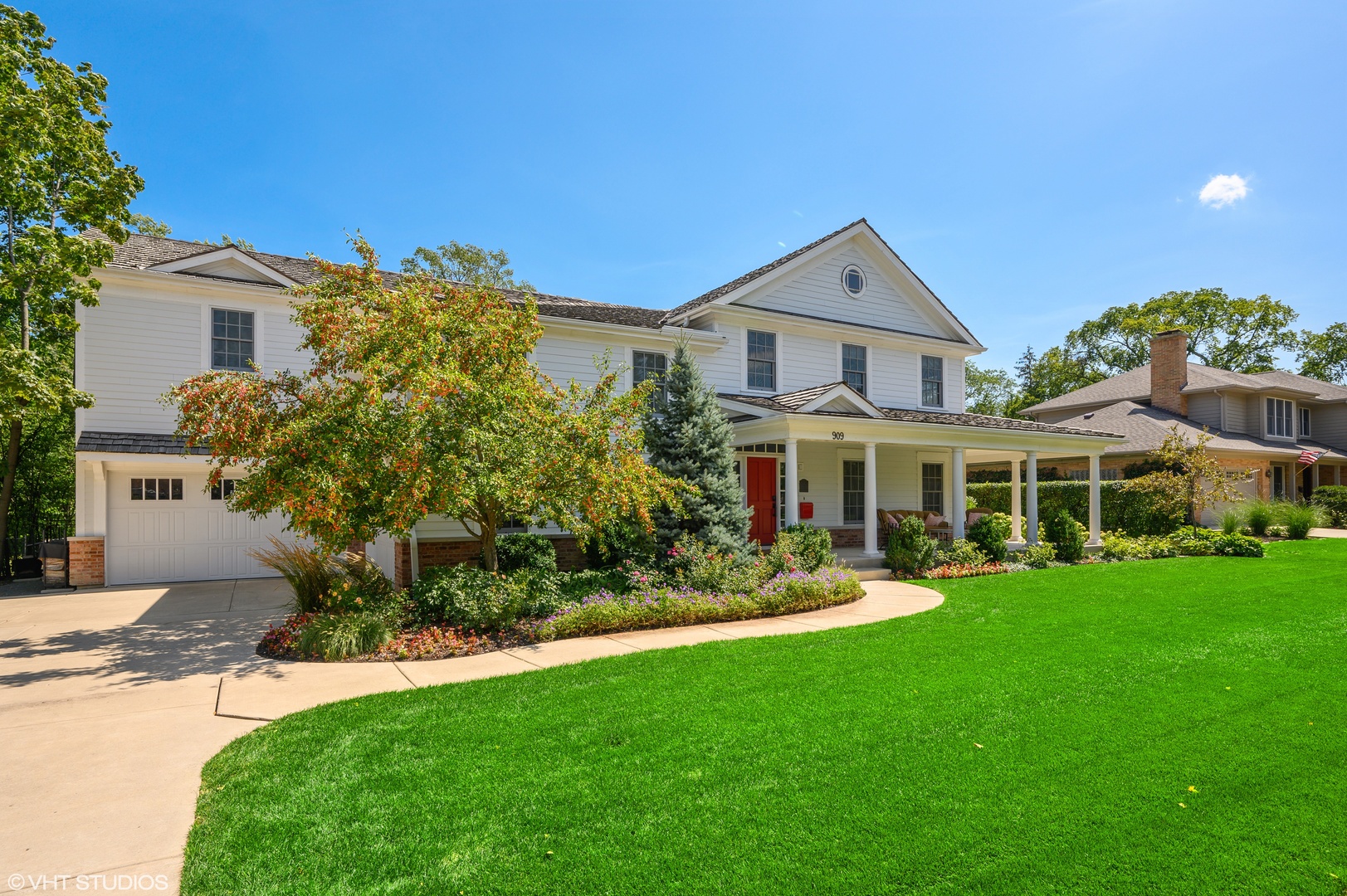 909 Windsor Road Glenview, IL 60025 - Photo 4 of 47 a front view of a house with a yard table and chairs